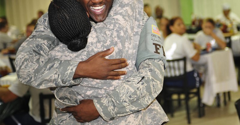 service members hugging