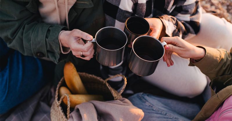 Three people holding coffee mugs