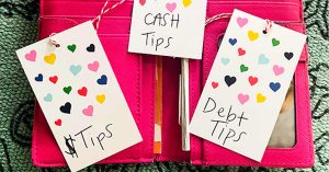 An open pink wallet with 3 notes in it that read “Cash Tips”, “$ Tips, “Debt Tips.”