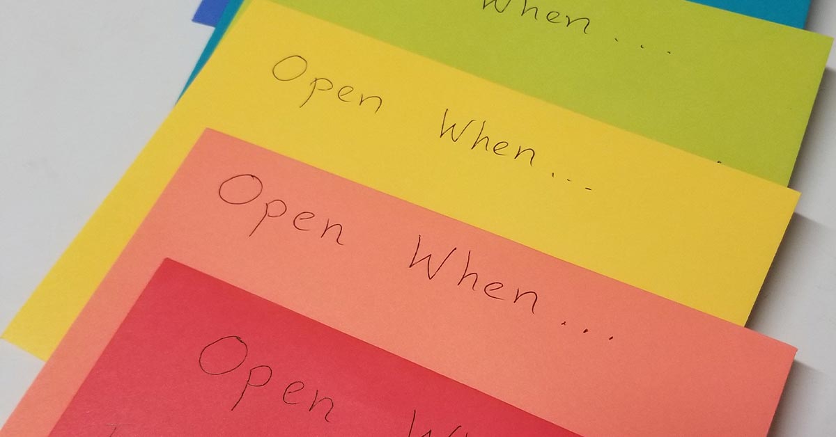 Multiple “open when” cards with stationary around them. 