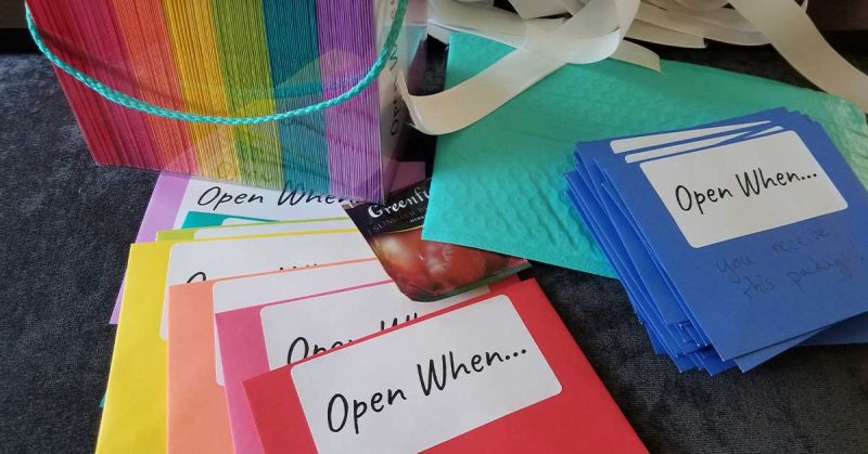 Six different “open when” cards laid out on a table.