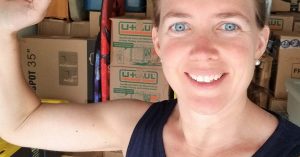 Woman smiling in front of moving boxes