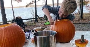 Sydney’s son carving a pumpkin.