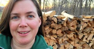 Lizann with a wood pile