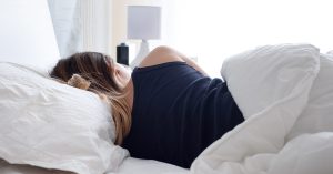 A person sleeping with their back facing the camera