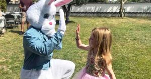 Child giving a bunny a high five