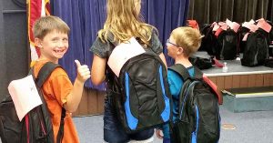 Lizann’s kids at a backpack giveaway