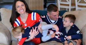 A family photo of Kristi, her husband and their two wearing football jerseys