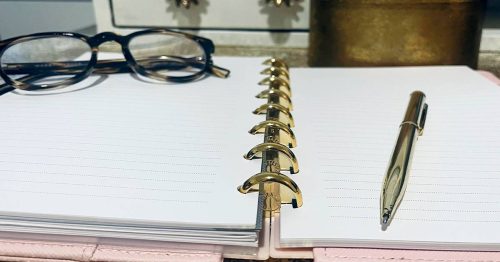 Notepad, pen and glasses