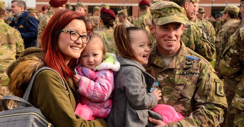 A military family smiles for the camera