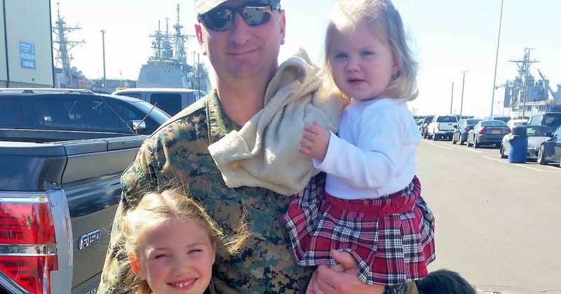 Service member and two children