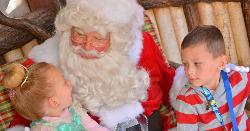 Boy and girl talking to Santa