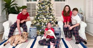 Family in front of the Christmas tree in pajamas