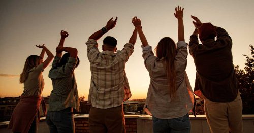 Teens celebrating during a sunset