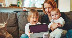 Woman and babies looking at an iPad