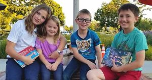 Children sitting together smiling