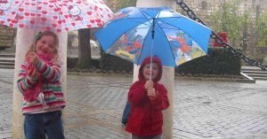 Children holding umbrellas