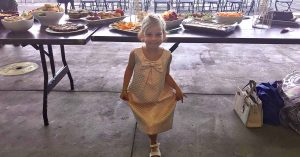 Kristi’s daughter posing in front of food