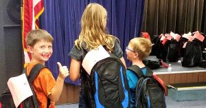 Lizann’s children with a backpack on