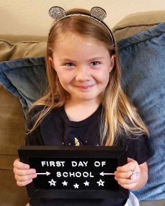Lizann’s daughter holding up a first day of school sign