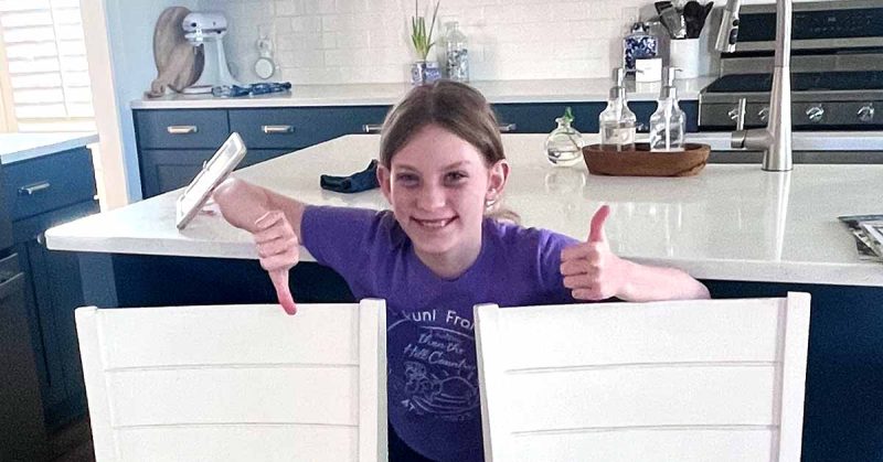 Kristi’s daughter giving thumbs up and down to decorations
