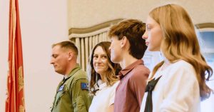 Kristi’s family stands proudly during a formal recognition ceremony.