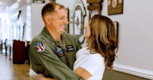 Kristi’s husband in a flight suit shares a joyful moment.