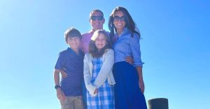 Kristi and her family outside smiling