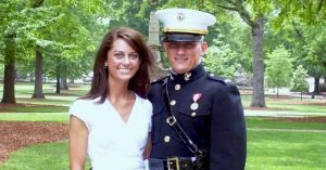 Kristi and her husband pose in a tree-lined park.