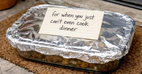 Foil-covered casserole dish on a countertop with a handwritten note that reads, “for when you just can’t even cook dinner”