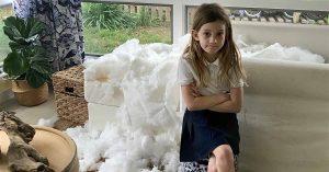 A couch ripped apart with Kristi’s daughter shrugging.