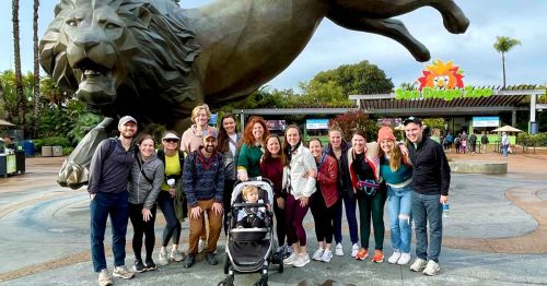 Group photo in front of the San Diego Zoo entrance and lion statue.
