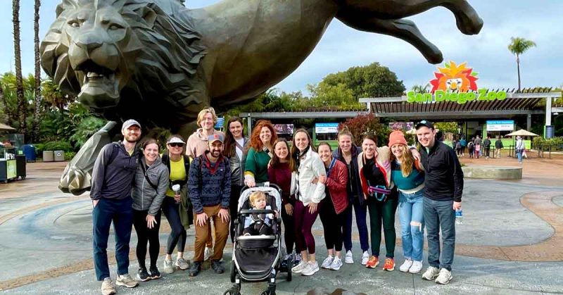 Group photo in front of the San Diego Zoo entrance and lion statue.