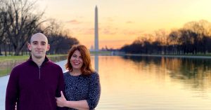 Lauren and a man standing beside the Reflecting Pool at sunset with the Washington Monument centered in the background.