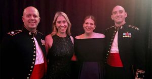 Lauren, her friend and their military spouses, pose together at an event.