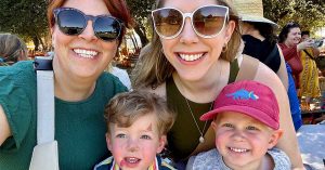 Lauren and her friend with their two young children taking a selfie.