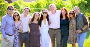 Lauren's group of friends smiling together outdoors.