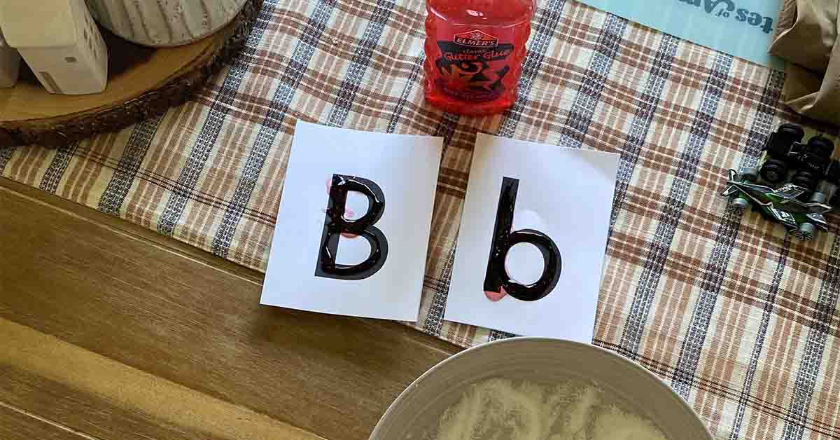 Alphabet cards showing uppercase “B” and lowercase “b” beside classroom materials for a hands-on letter learning activity.