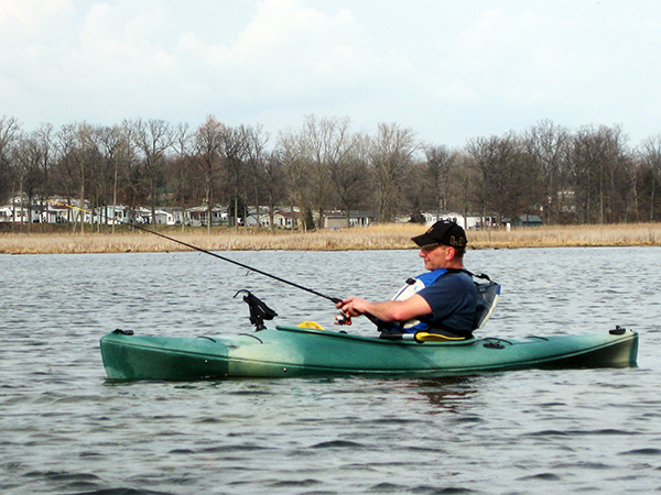 A man fishing and kayaking