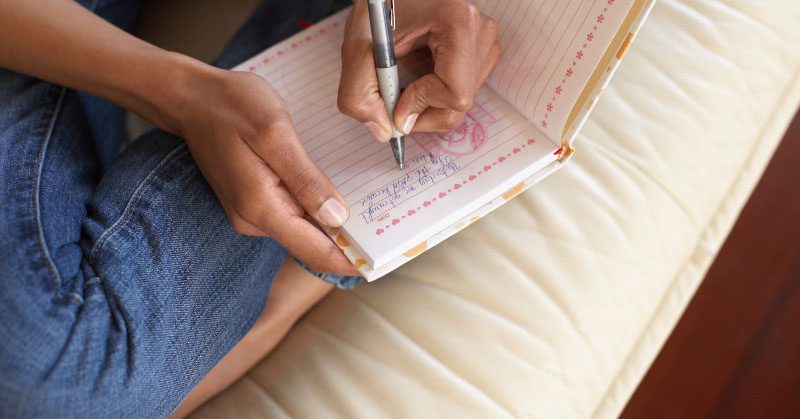 A woman writing in a journal