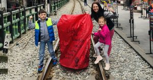 Children posing on a train track