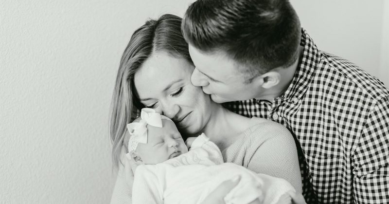 A couple holding a newborn baby