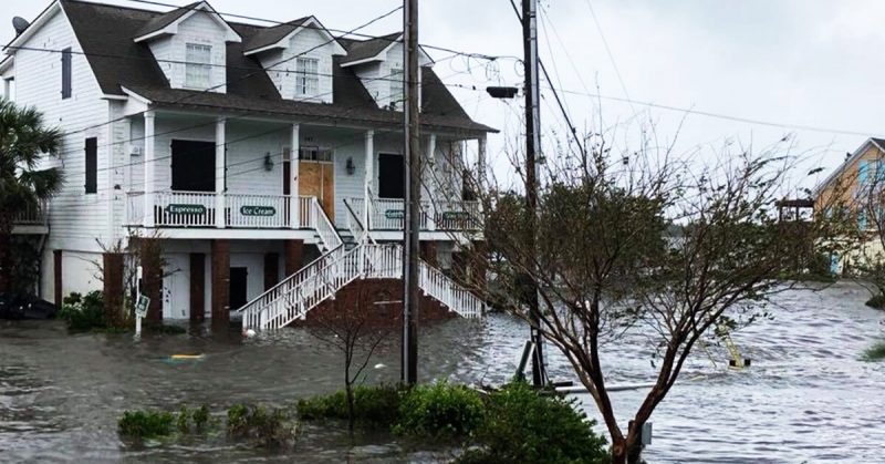 house surrounded by flood water