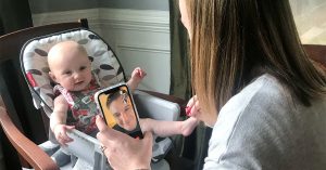 A mother and baby posing with a baby on FaceTime