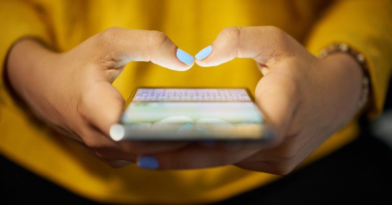Closeup of a woman's hands using a smartphone