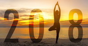 Woman doing yogo on the beach during a sunrise