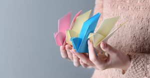 A person holding origami