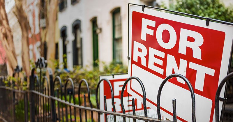 A closeup of a "For Rent" sign