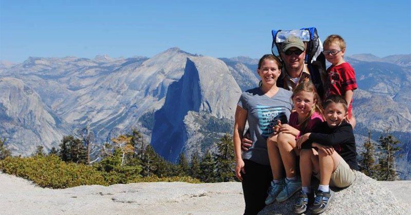 A family posing for a photo at Yosemite National Park