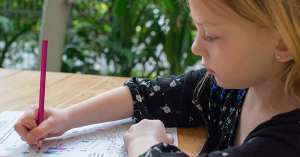 A child coloring on a piece of paper